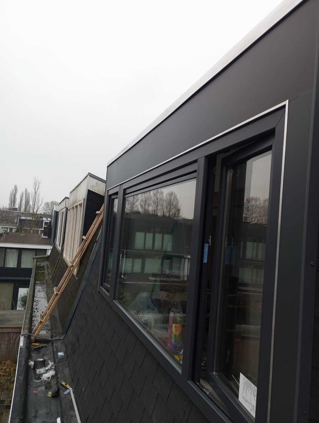 After: a new wall with large windows where the sloping roof was