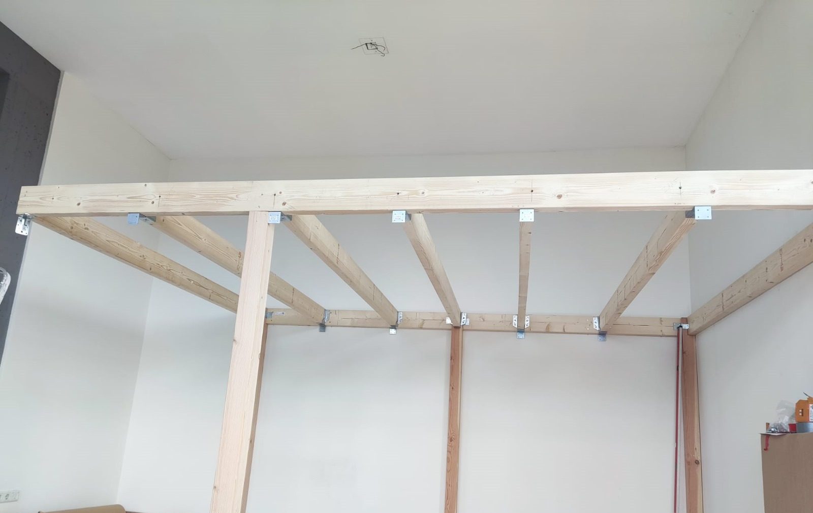 A timber frame for a mezzanine in a high room
