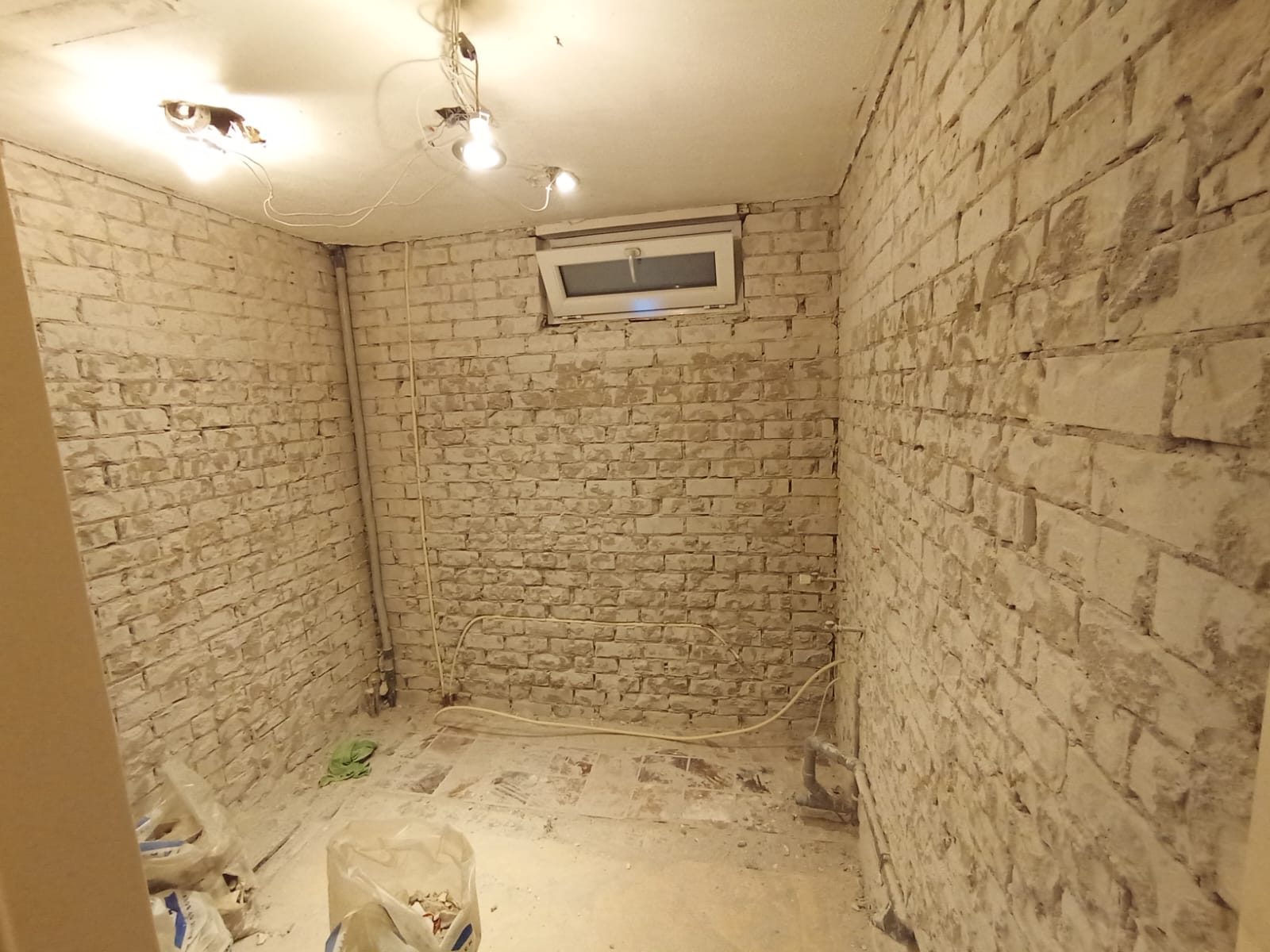 A small room stripped back to bare brick