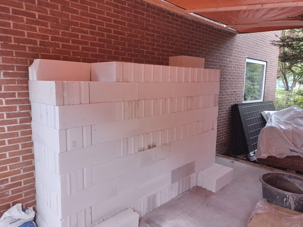 White building blocks for an inner wall beside new brickwork