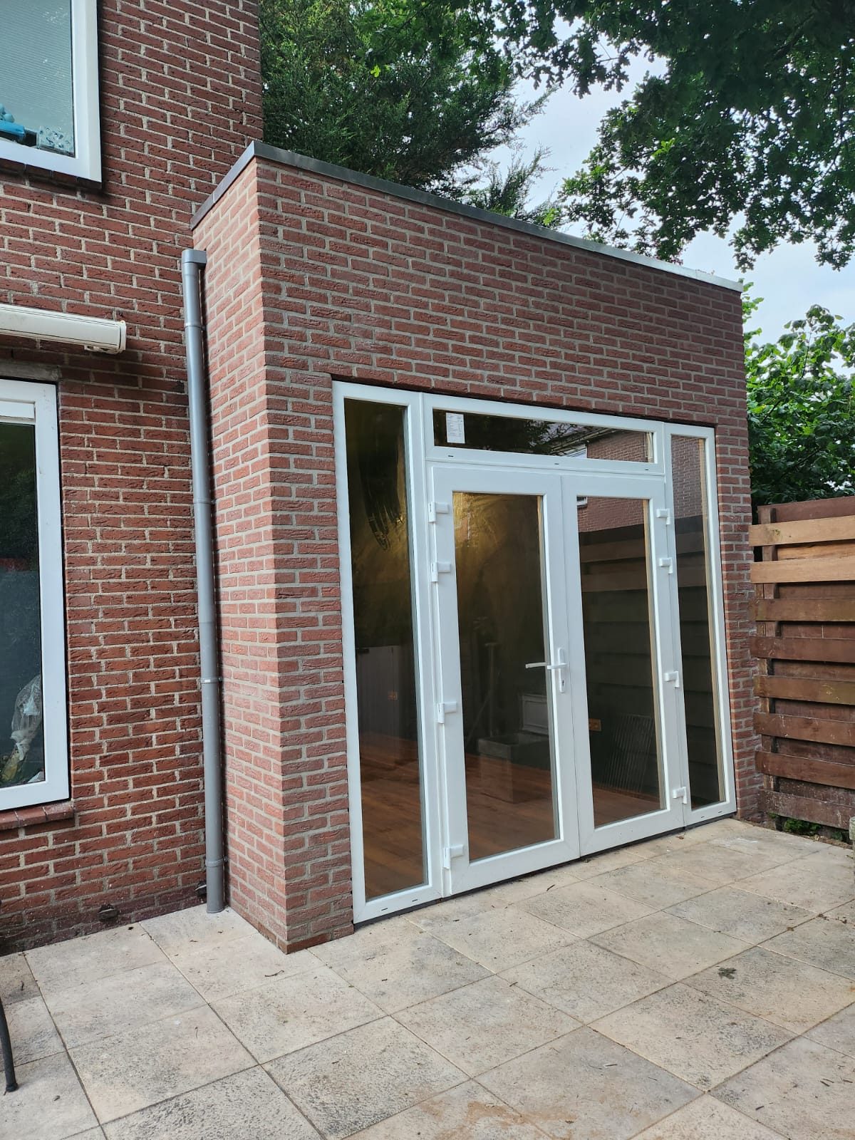 After: a brick side extension with glass double doors