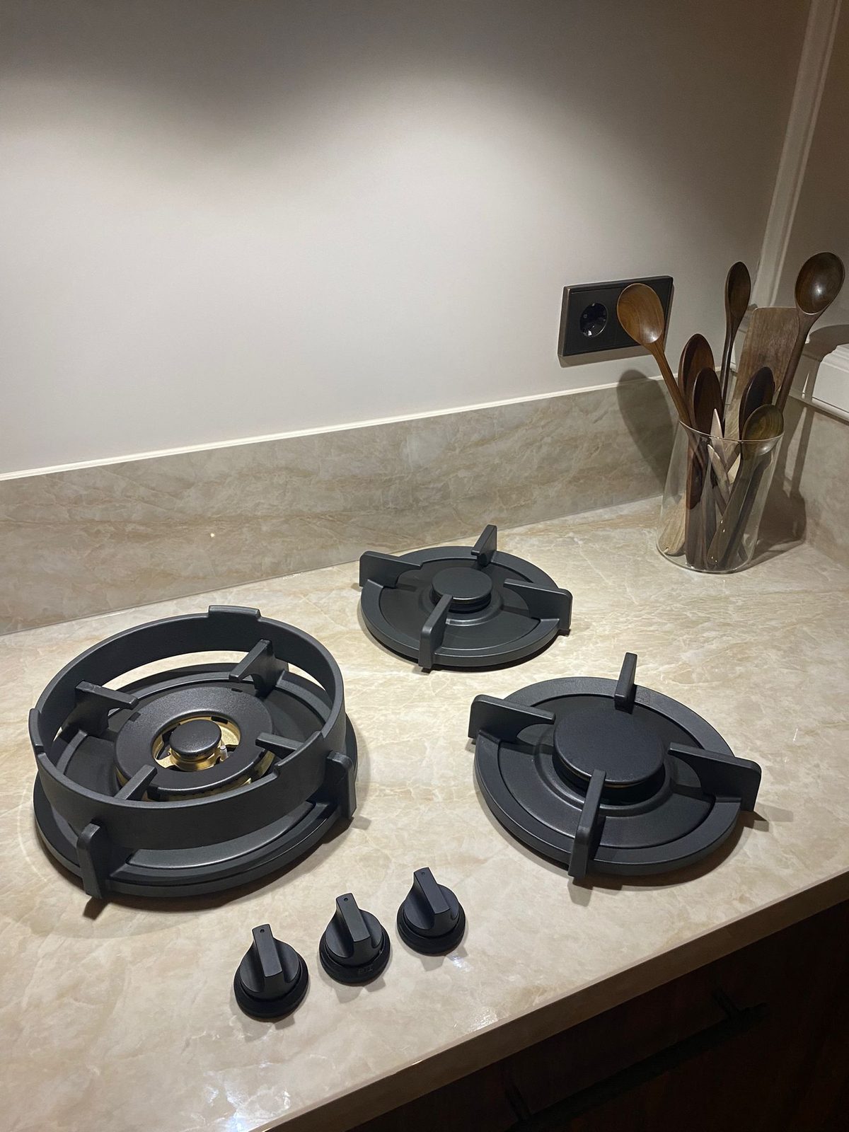 A gas hob set into a stone-look worktop
