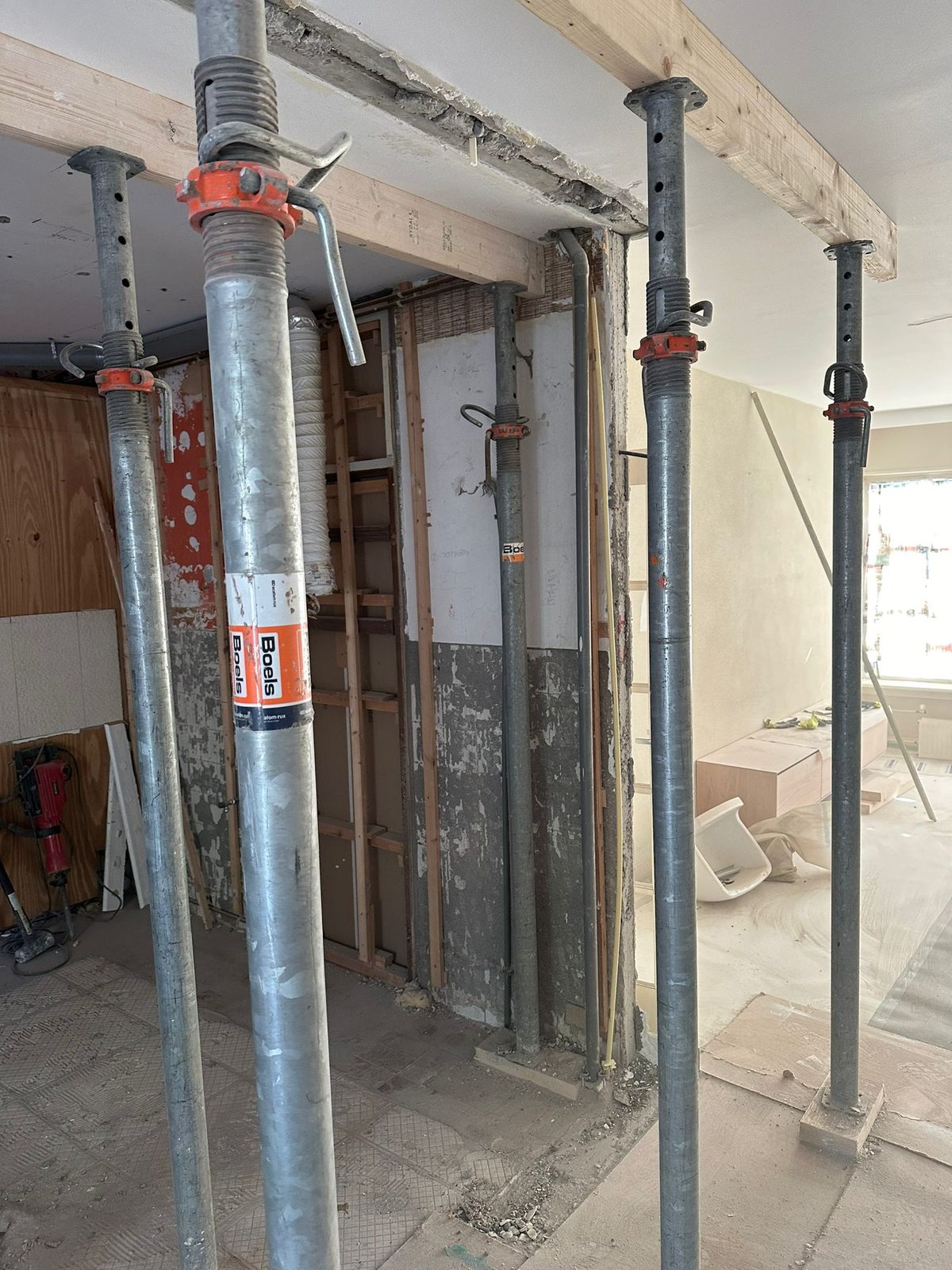Steel props holding up the ceiling while the wall between the kitchen and the living room comes out