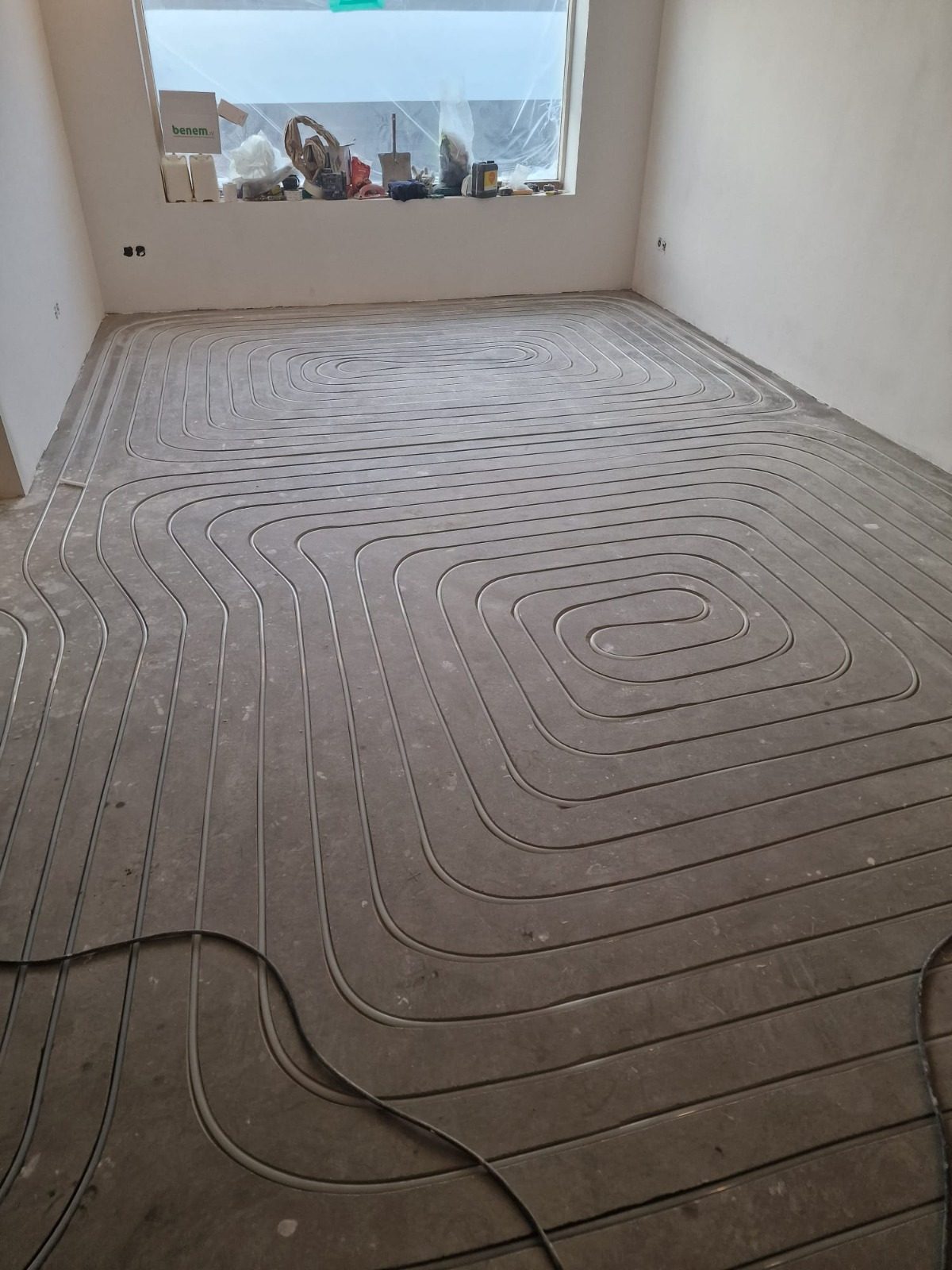 Channels milled into the floor for the heating pipes