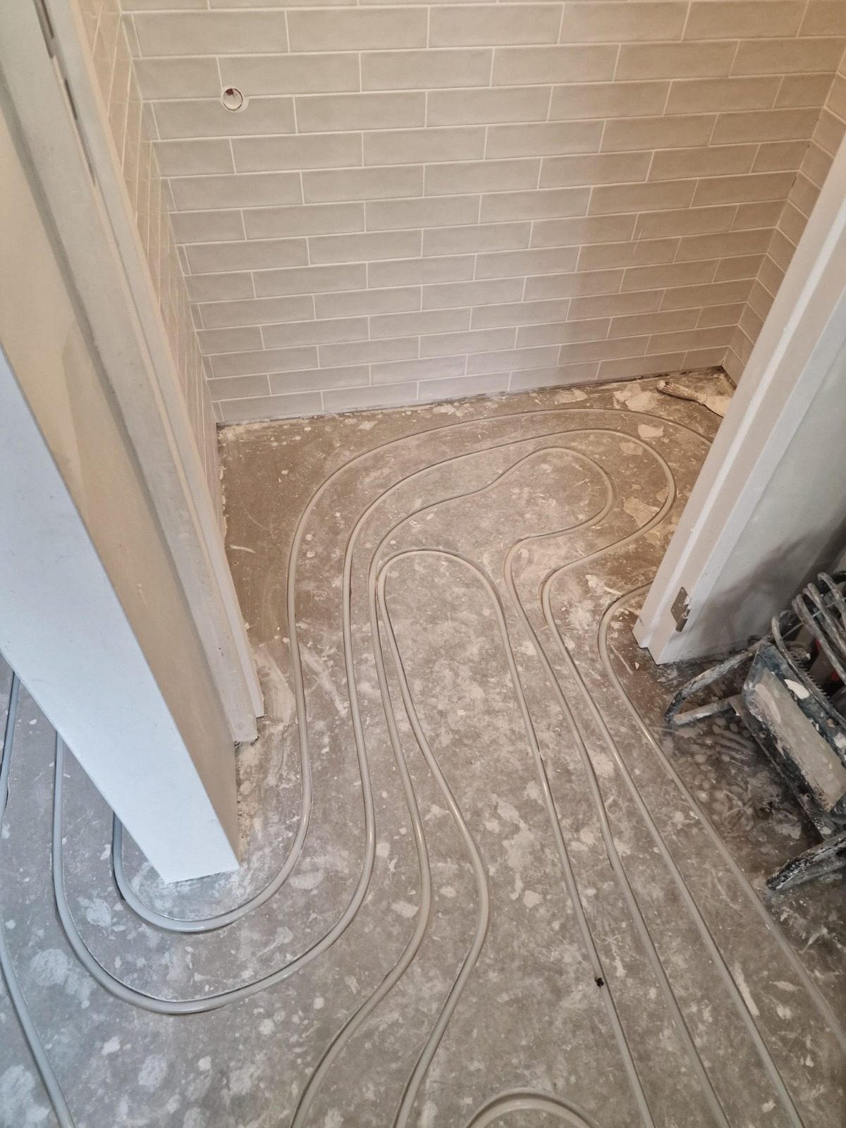 Before: heating pipes in milled channels in a small toilet